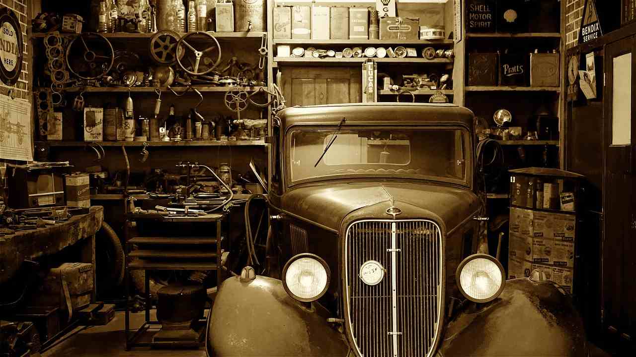 Vintage automobile inside a classic mechanic garage filled with tools, parts, and restoration equipment, representing Tire dealer financing, transmission shop financing, repair shop payroll financing, engine rebuild shop financing, and mechanic shop startup financing for automotive entrepreneurs building, expanding, and modernizing repair businesses.