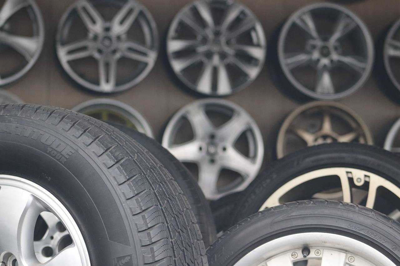 Display of automotive tires and alloy wheels inside a professional tire and wheel shop, representing garage building loans, auto repair software financing, automotive revenue financing, engine rebuild shop financing, and vehicle repair shop financing for growing automotive service businesses investing in facilities, technology, inventory, and expansion.