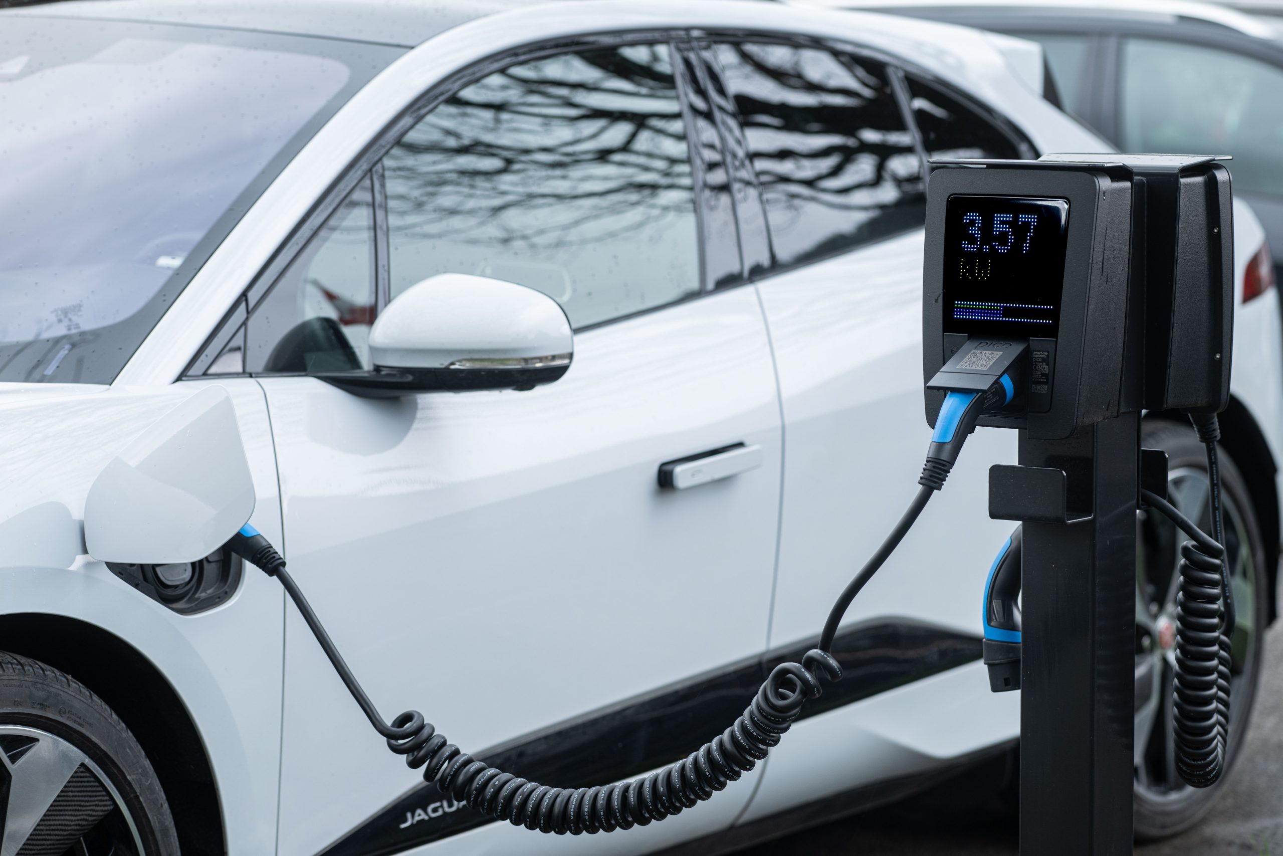 Electric vehicle charging at a commercial charging station, showcasing modern automotive technology and infrastructure investments supported by Fleet repair facility funding, repair shop liquidity financing, shop automation financing, diagnostic equipment financing, and frame machine financing for repair facilities expanding into EV service, fleet maintenance, and advanced automotive repair operations.