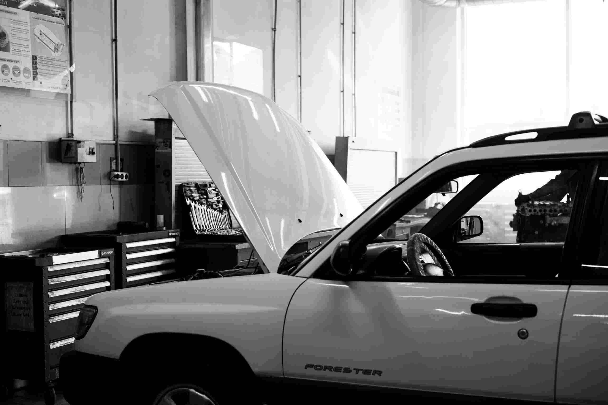 Automotive repair facility with a vehicle undergoing maintenance, illustrating Garage expansion financing, repair shop scaling capital, mechanic shop growth financing, automotive lift financing, and shop compressor financing used to support equipment upgrades, larger service bays, and business growth.