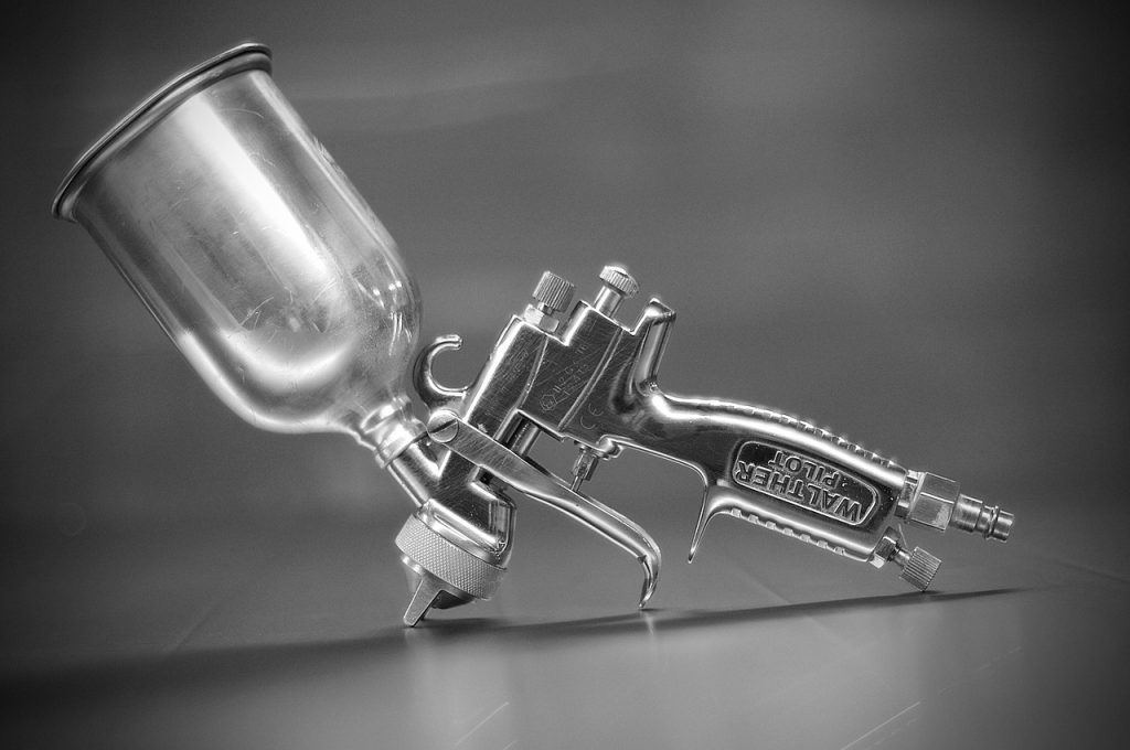 Professional automotive paint spray gun representing Automotive operating funds, auto repair capital providers, automotive inventory funding, garage construction financing, and automotive finance programs for automotive repair, collision, and refinishing businesses.
