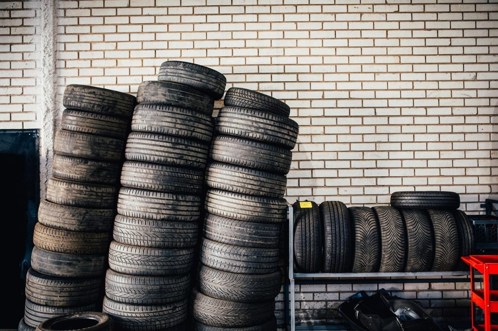 Stacks of automotive tires inside a tire and repair shop representing Automotive business startup funding, repair garage funding, emissions testing equipment financing, automotive tool financing, and tire changer financing for automotive business owners.