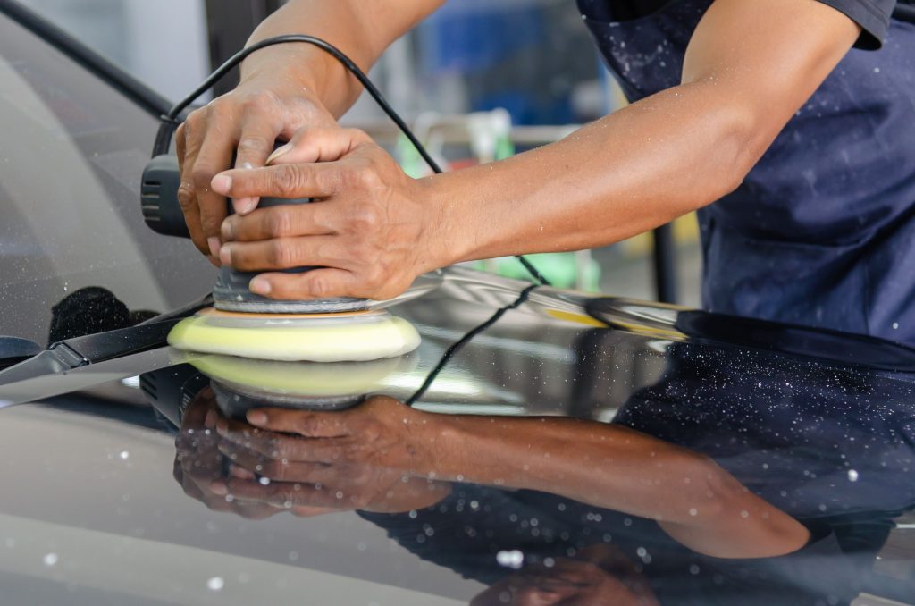 Automotive technician polishing a vehicle with professional detailing equipment, representing Garage financing specialists, automotive lift financing, repair shop funding marketplace, auto repair shop startup loans, and auto repair capital providers for automotive service businesses.