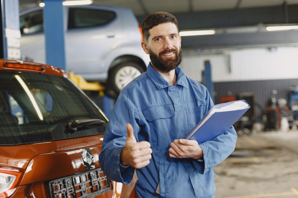Modern auto repair shop with vehicles, service bays, lifts, tools, and diagnostic equipment representing automotive lift financing, garage equipment financing, body shop technology financing, garage startup financing, and auto repair shop startup loans.